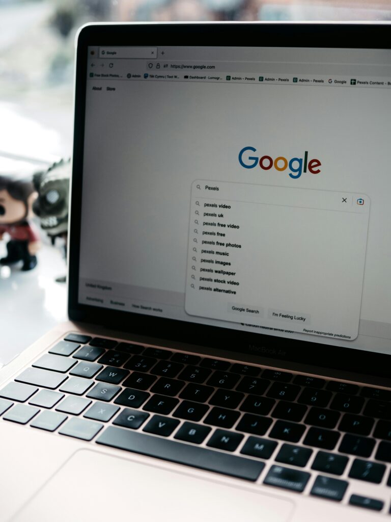 A close-up shot of a laptop displaying a Google search page with related searches visible.